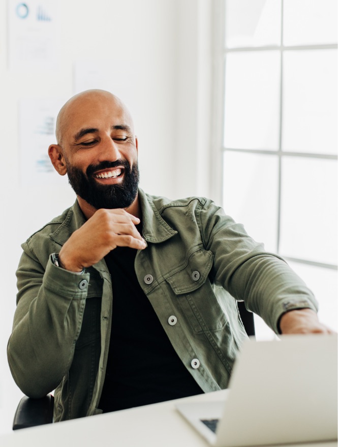 Smiling executive with laptop - Starlink satellite connectivity for remote locations