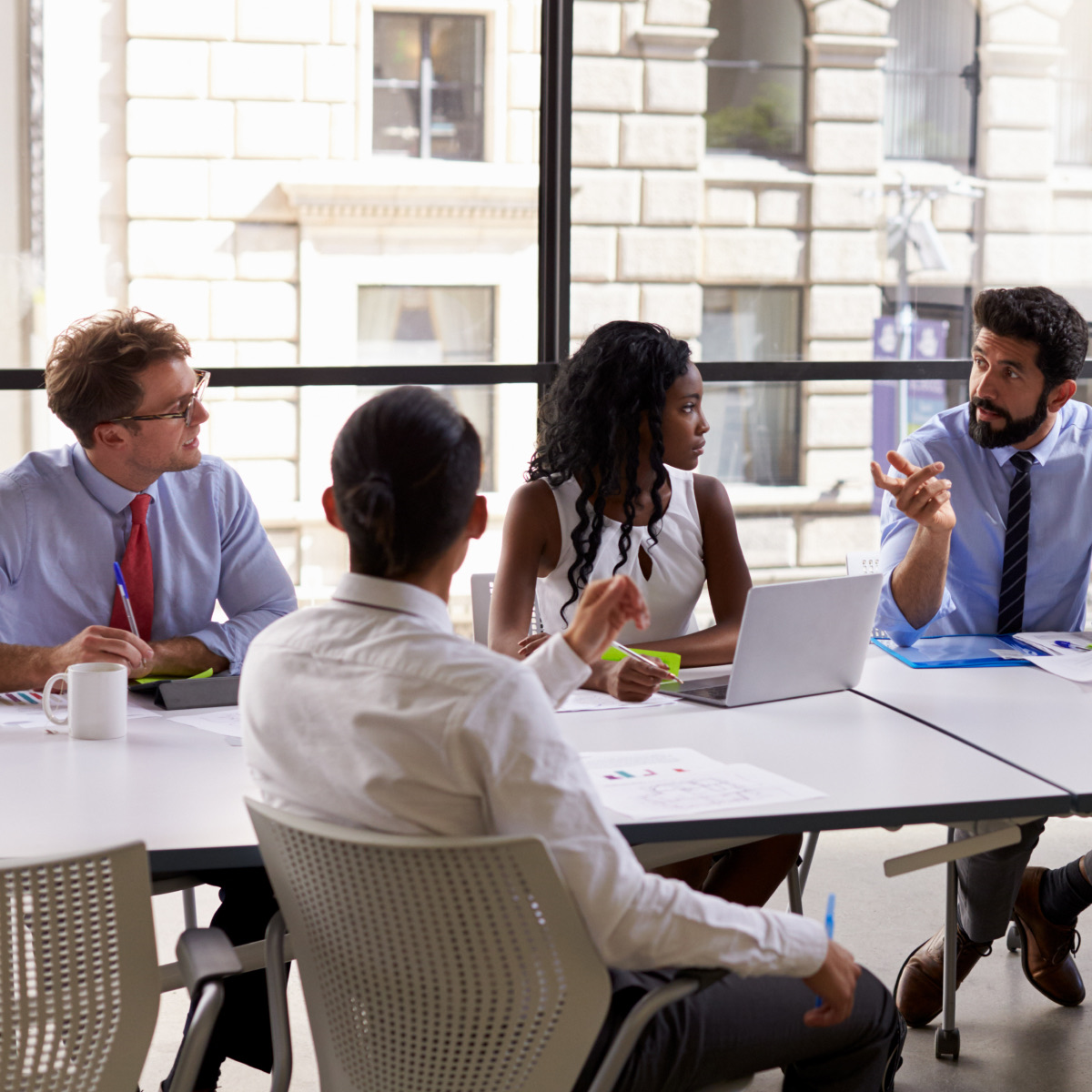 Professional collaborating at laptop - Teams Operator Connect carrier-grade telephony